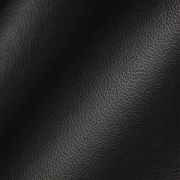 Close-up of black sustainable biomaterial with a matte leather-like texture and subtle surface grain.